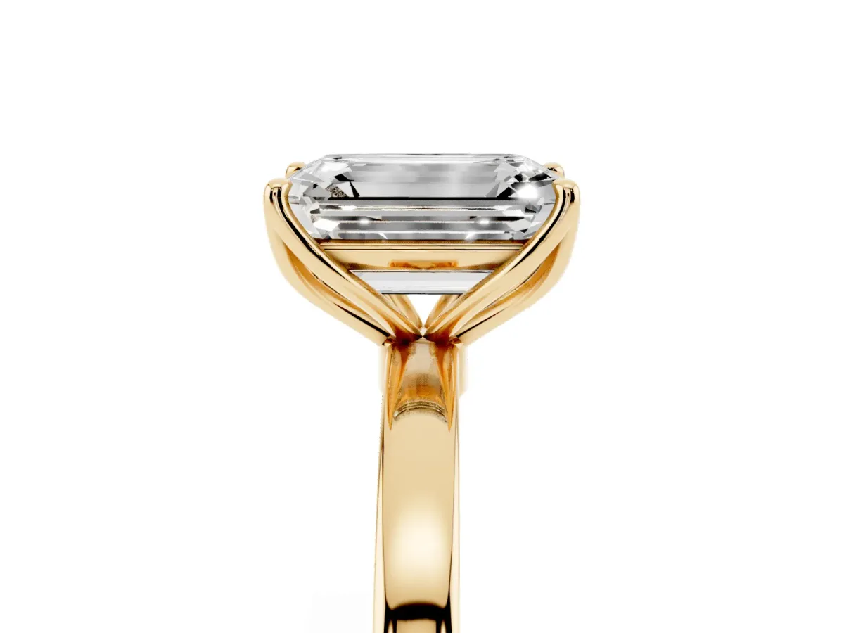 Emerald Cut Diamond Solitaire Ring with Thin Band and Prong Setting Yellow gold