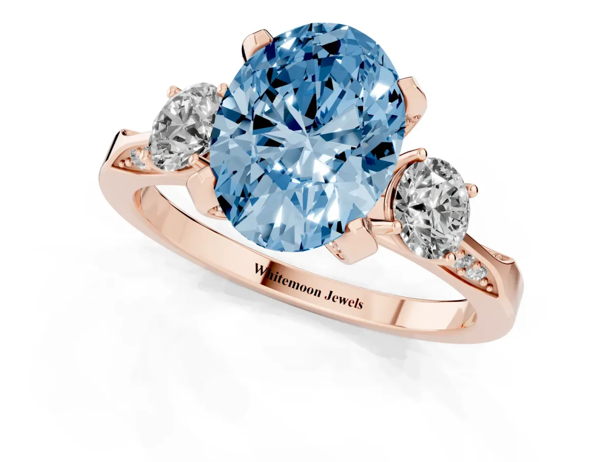 Fancy Blue Oval Cut Brilliant Three-Stone Diamond Ring with Pavé Band and Four-Prong Setting Rose gold