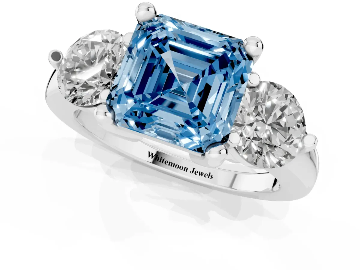 Fancy Blue Three-Stone Asscher Cut Brilliant Cut Solitaire Ring with Prong Setting on a Classic Band Platinum