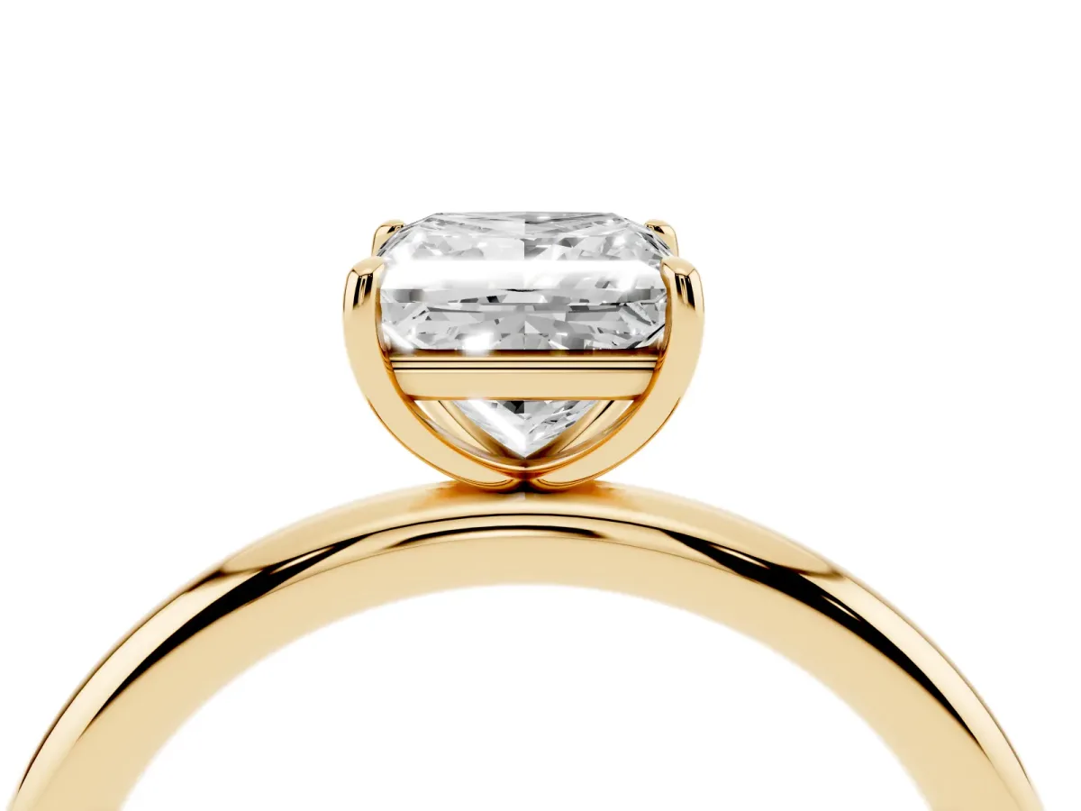 Princess Cut Solitaire Diamond Ring with Four-Prong Setting on a Plain Band Yellow gold