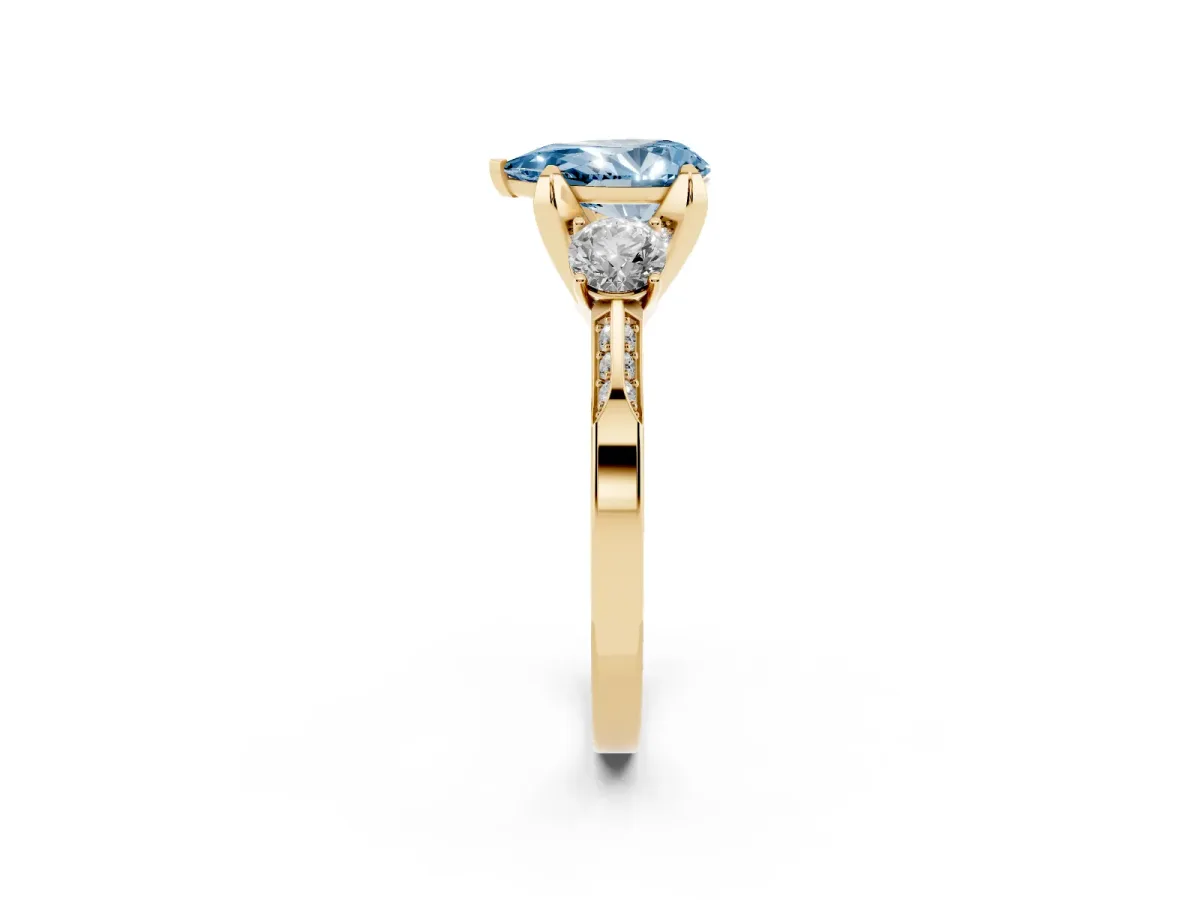 Fancy Blue Pear Cut Brilliant Three-Stone Diamond Ring with Pavé Band and Four-Prong Setting Yellow gold