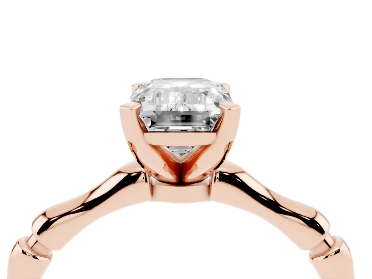 Emerald Cut Solitaire Diamond Ring with Bamboo Band and Four-Prong Setting Rose gold