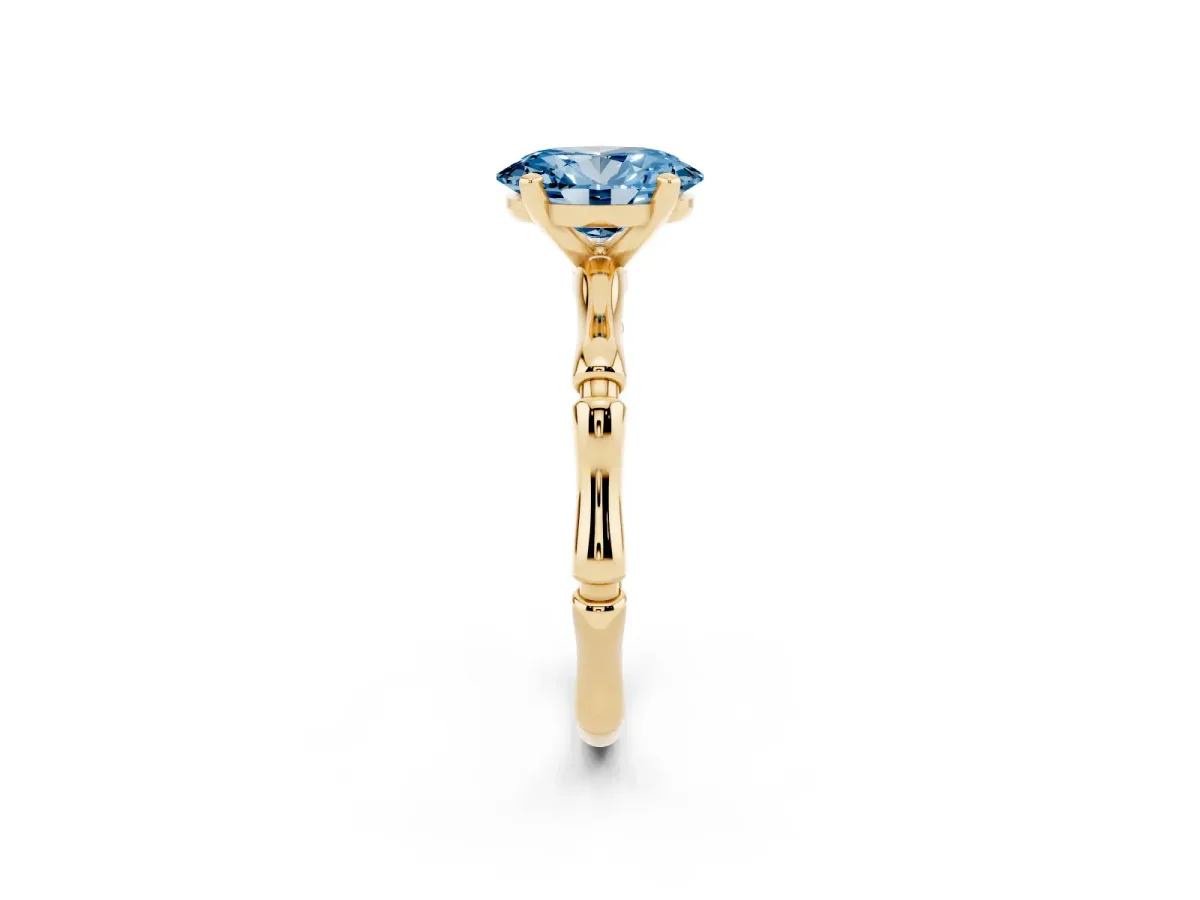 Fancy Blue Oval Cut Solitaire Diamond Ring with Bamboo Band and Four-Prong Setting Yellow gold