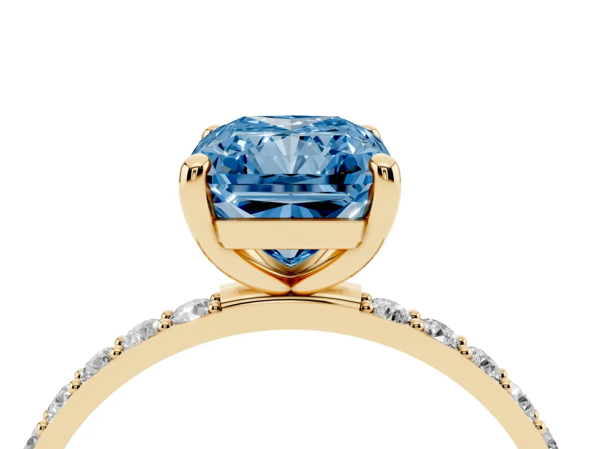 Fancy Blue Radiant Cut Diamond Solitaire Ring with Round Pavé Band and Prong Setting Yellow gold