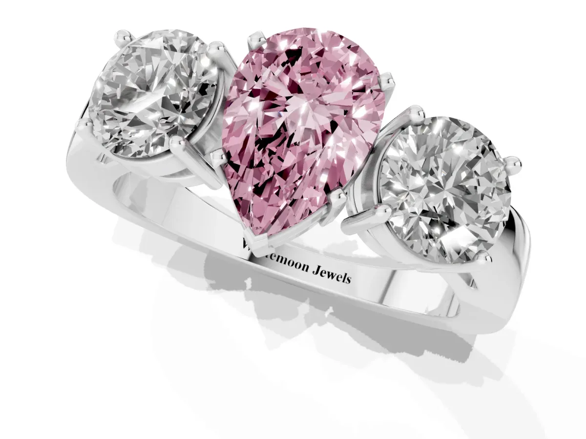 Fancy Pink Three-Stone Pear Cut Diamond Ring with Round Side Stones, Classic Band, and Four-Prong Setting Platinum
