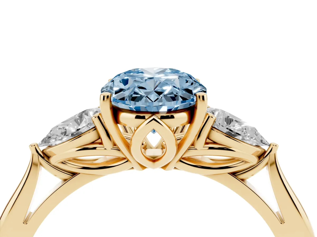 Fancy Blue Three-Stone Oval Cut Diamond Ring with Pear Side Stones in Four-Prong Setting Yellow gold