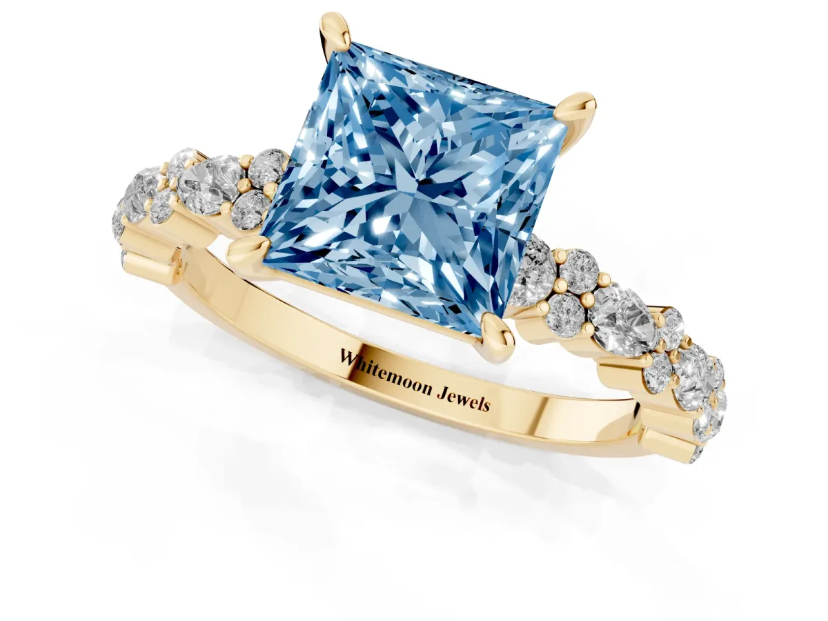 Fancy Blue Princess Cut Diamond Side Stone Solitaire Ring with Round and Four-Prong Setting Yellow gold