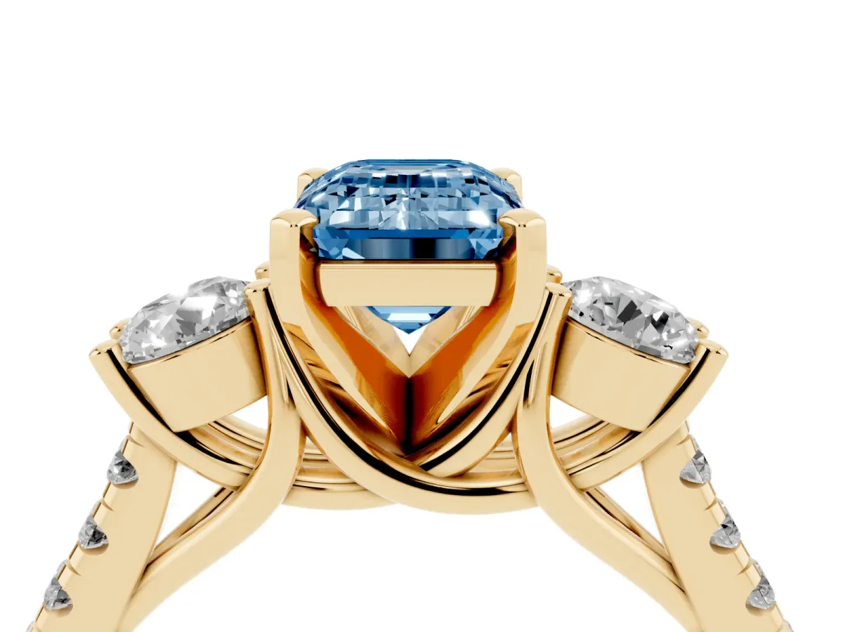 Fancy Blue Three-Stone Emerald Cut Diamond Pavé Band with Four-Prong Setting Yellow gold