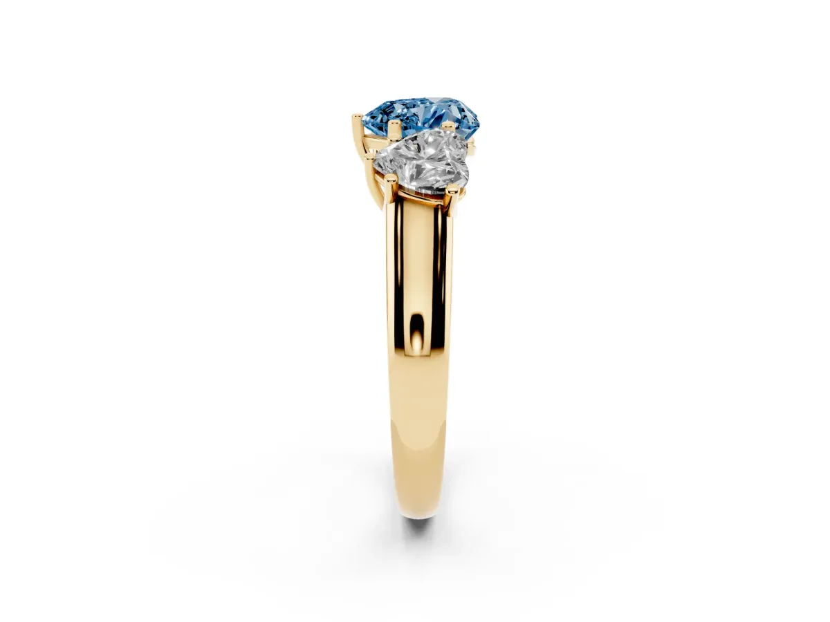 Fancy Blue Heart Cut Three-Stone Diamond Ring with Prong Setting on a Classic Band Yellow gold