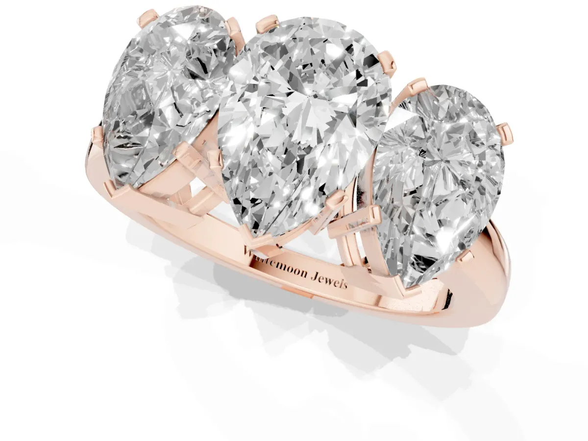 Three-Stone Pear Cut Cut Diamond Ring with Channel Set Band and Four-Prong Setting Rose gold