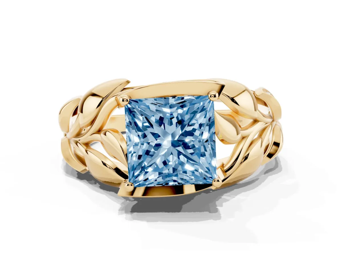 Fancy Blue Princess Cut Diamond Leaf-Inspired Engagement Ring with Round Accents and Prong Setting Yellow gold