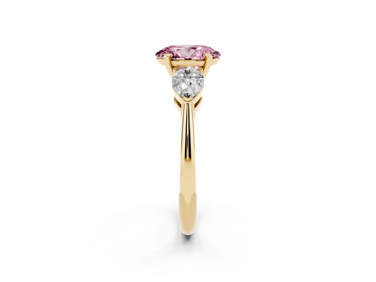 Fancy Pink Three-Stone Oval Cut Diamond Ring with Pear Side Stones and Four-Prong Setting Yellow gold