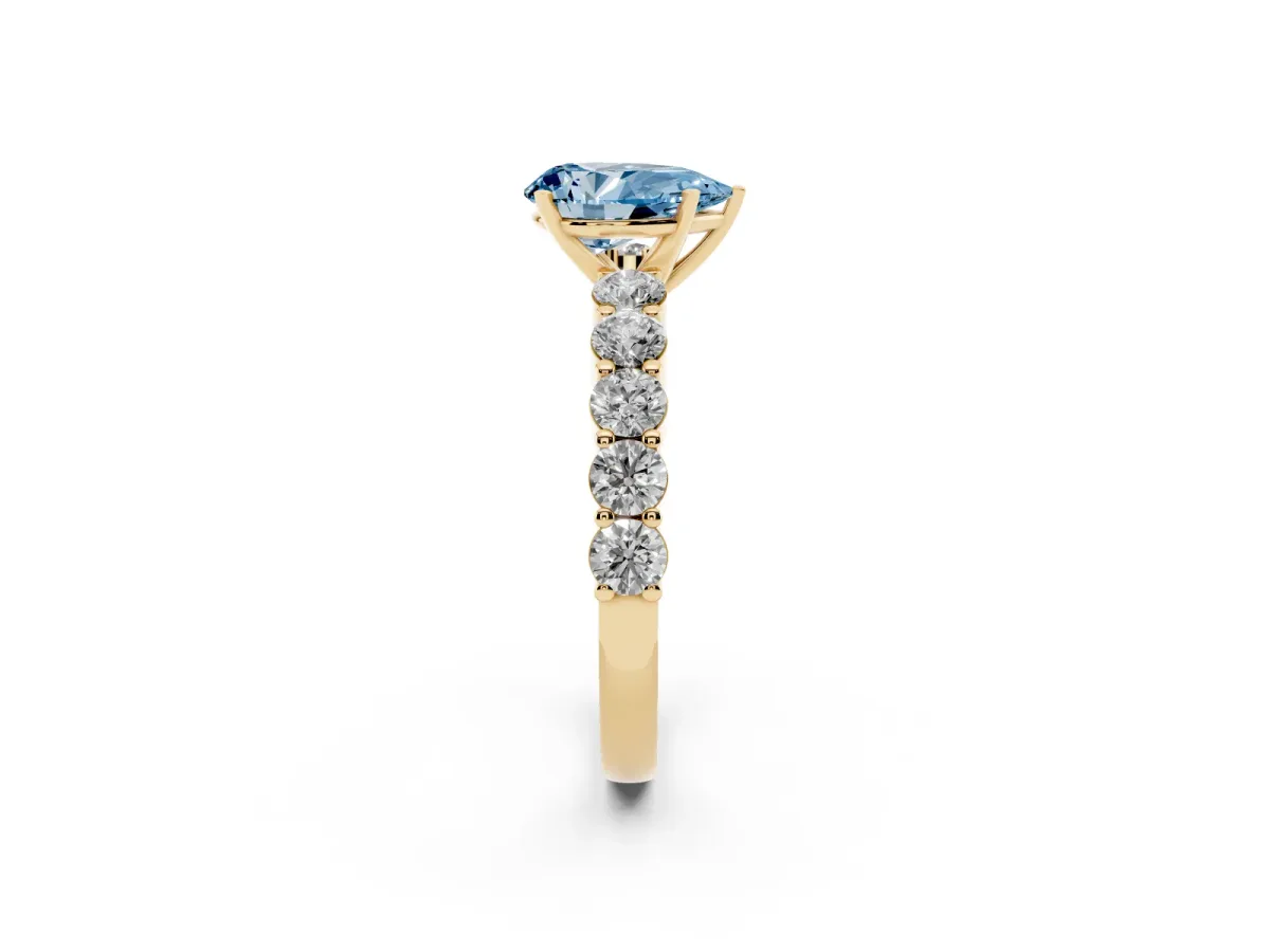 Fancy Blue Pear Cut Diamond Solitaire Ring with Shared Prong Round Side Stones Yellow gold