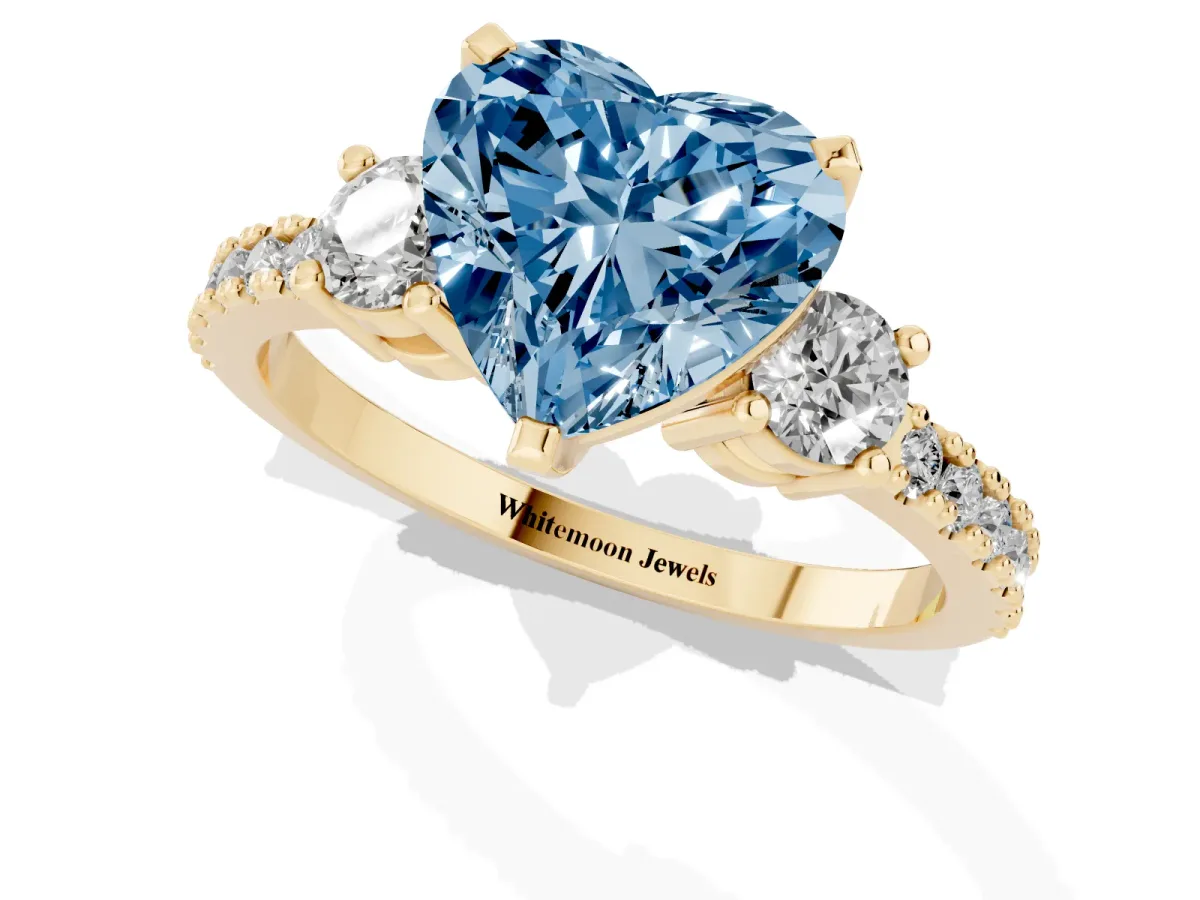 Fancy Blue Heart Cut Three-Stone Diamond Pavé Band with Prong Setting Yellow gold