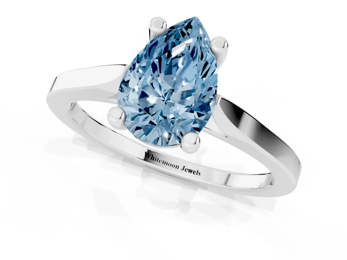 Fancy Blue Pear Cut Solitaire Diamond Ring with Four-Prong Setting and Tapered Band Platinum