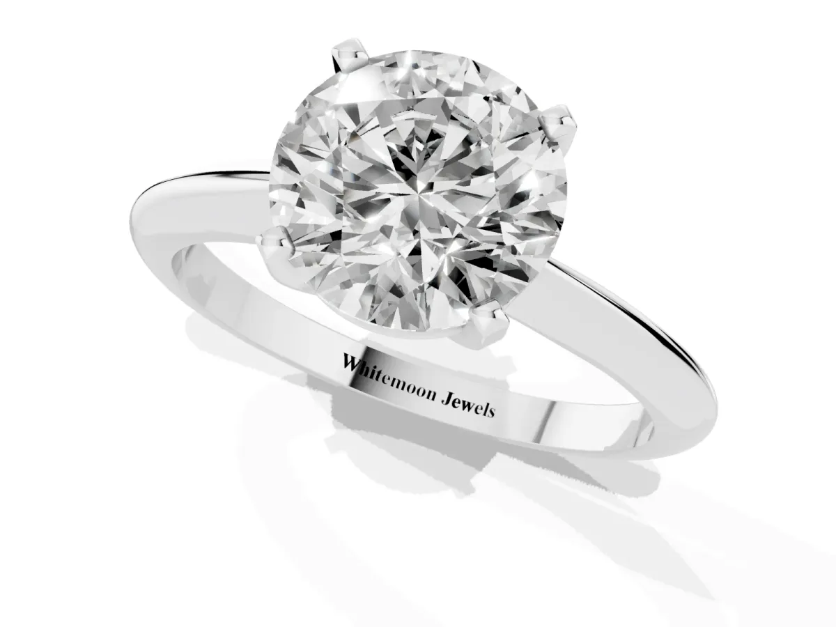 Round Cut Cut Solitaire Ring with Four-Prong Setting on a Classic Band Silver