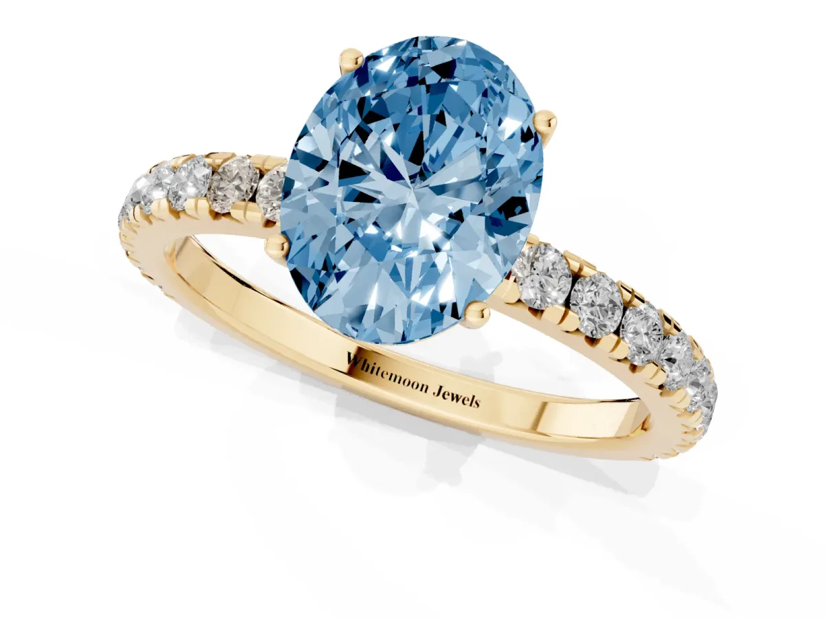 Fancy Blue Oval Cut Diamond Pavé Solitaire Engagement Ring with Four-Prong Setting Yellow gold