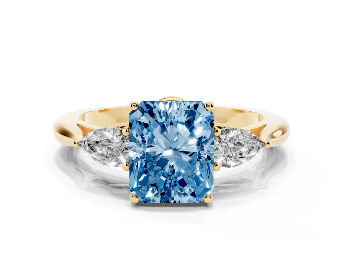 Fancy Blue Three-Stone Radiant Cut Brilliant Diamond Solitaire Ring with Tapered Band and Four-Prong Setting Yellow gold