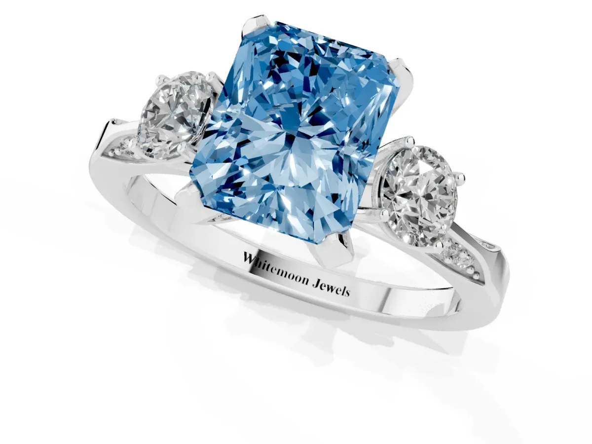 Fancy Blue Radiant Cut Brilliant Three-Stone Diamond Ring with Pavé Band and Four-Prong Setting Silver