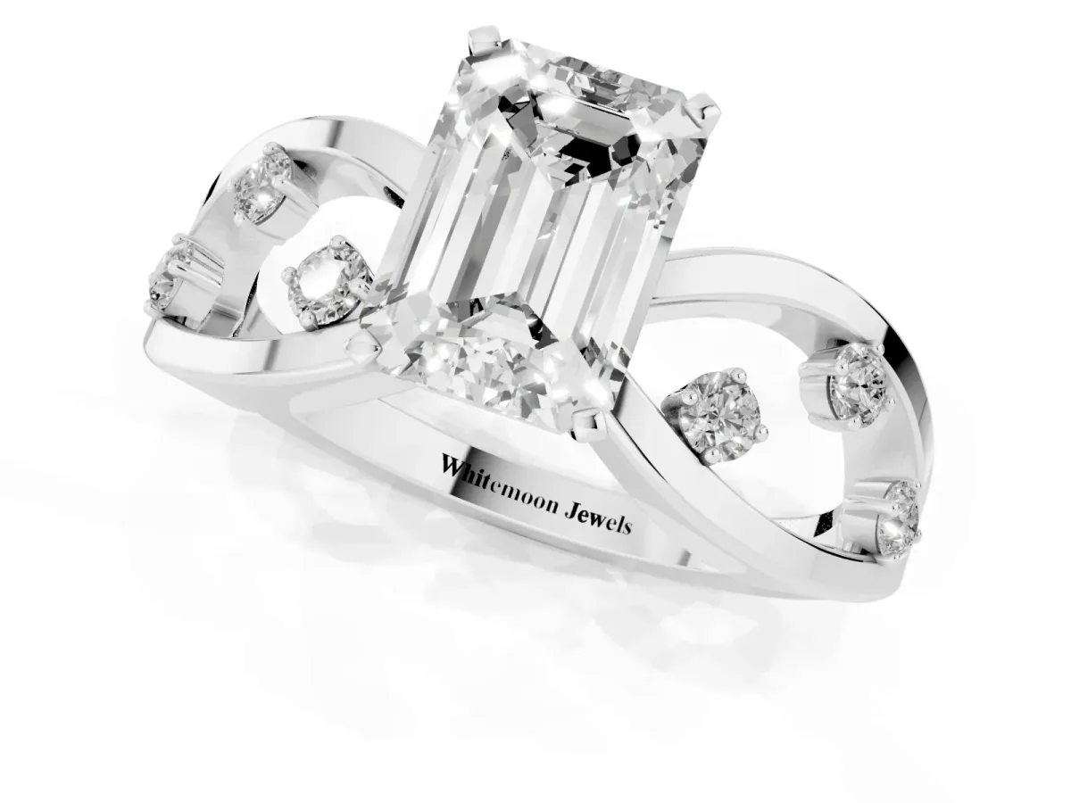 Emerald Cut Cut Solitaire Diamond with Side Stones on Criss-Cross Band and Four-Prong Setting Platinum