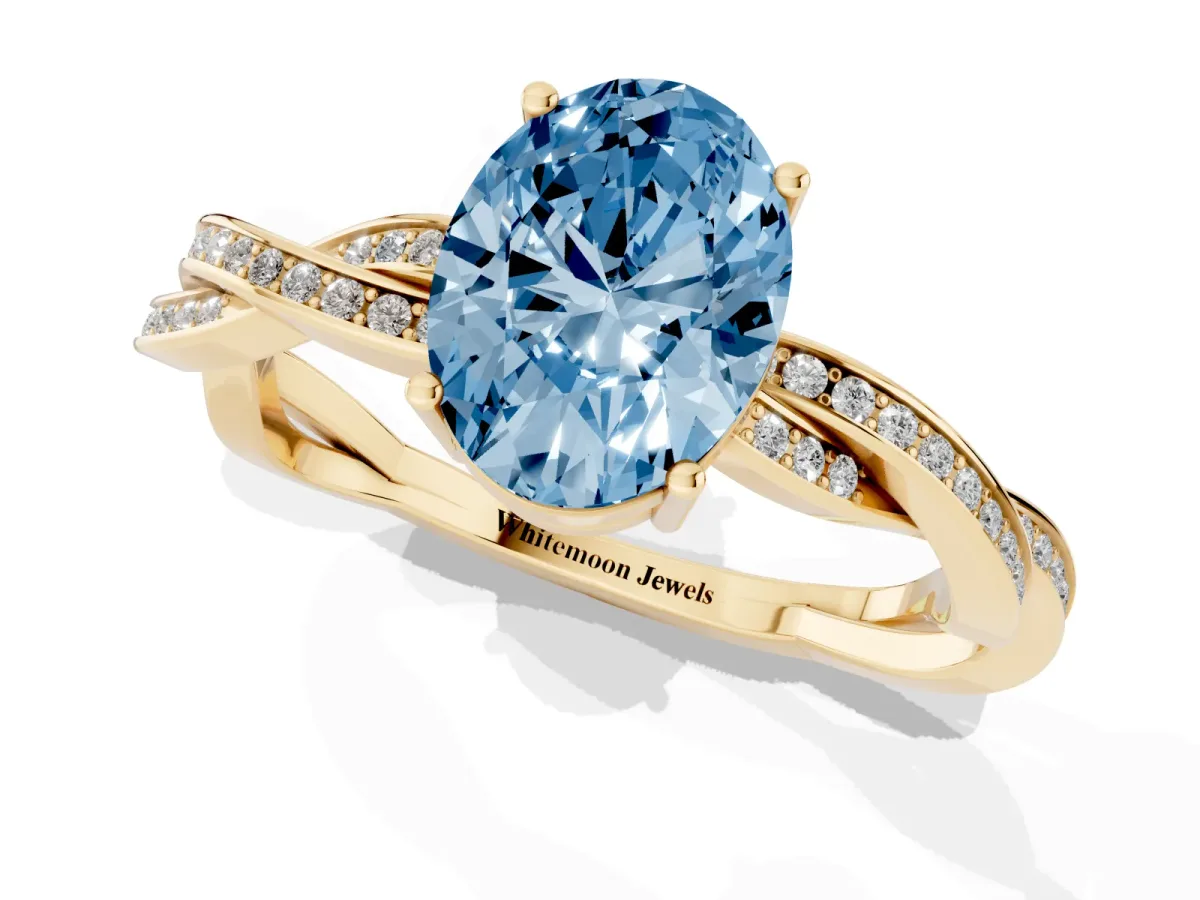 Fancy Blue Oval Cut Solitaire Twisted Pave Diamond Ring with Four-Prong Setting Yellow gold