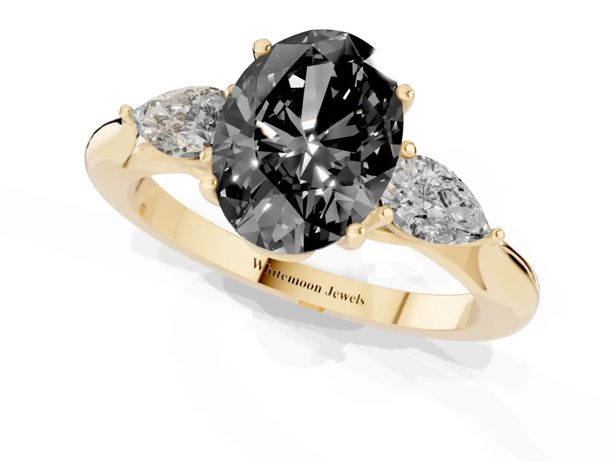Fancy Black Three-Stone Oval Cut Brilliant Diamond Solitaire Ring with Tapered Band and Four-Prong Setting Yellow gold