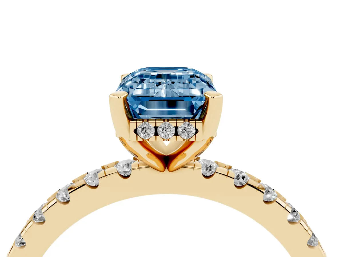 Fancy Blue Emerald Cut Diamond Solitaire Ring with Round Pavé Band and Four-Prong Setting Yellow gold