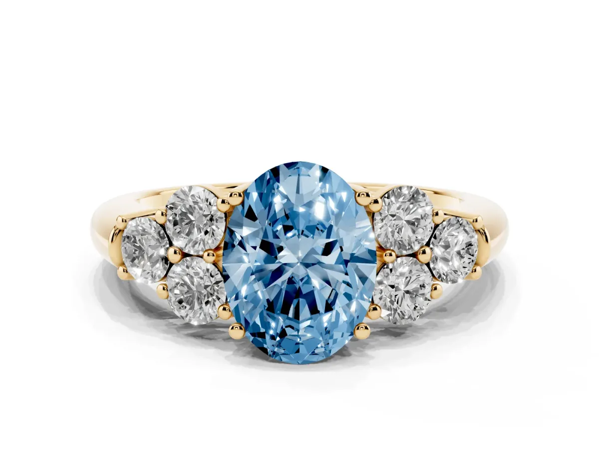 Fancy Blue Oval Cut Cut Diamond Cluster Ring with Round Accent Stones and Prong Setting on a Classic Band Yellow gold