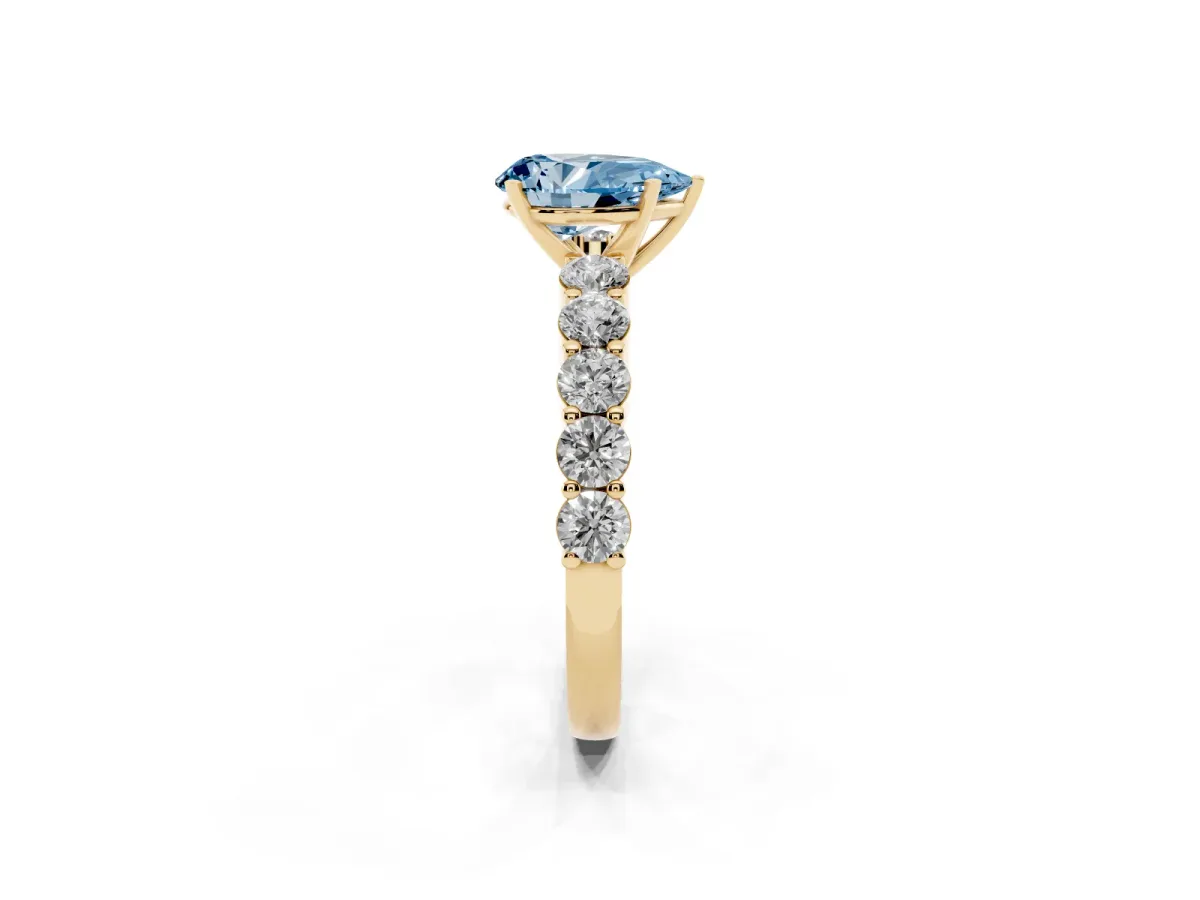 Fancy Blue Pear Cut Diamond Solitaire Ring with Shared Prong Round Side Stones Yellow gold