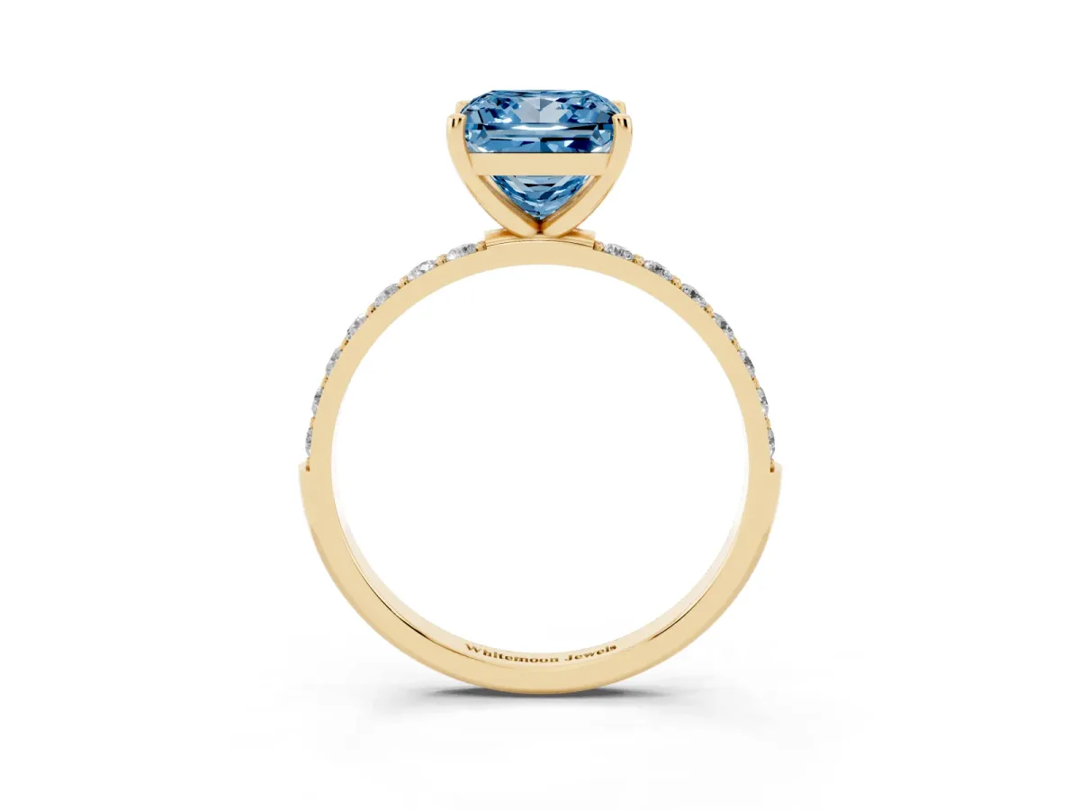 Fancy Blue Princess Cut Diamond Solitaire Ring with Round Pavé Shoulders and Prong Setting Yellow gold