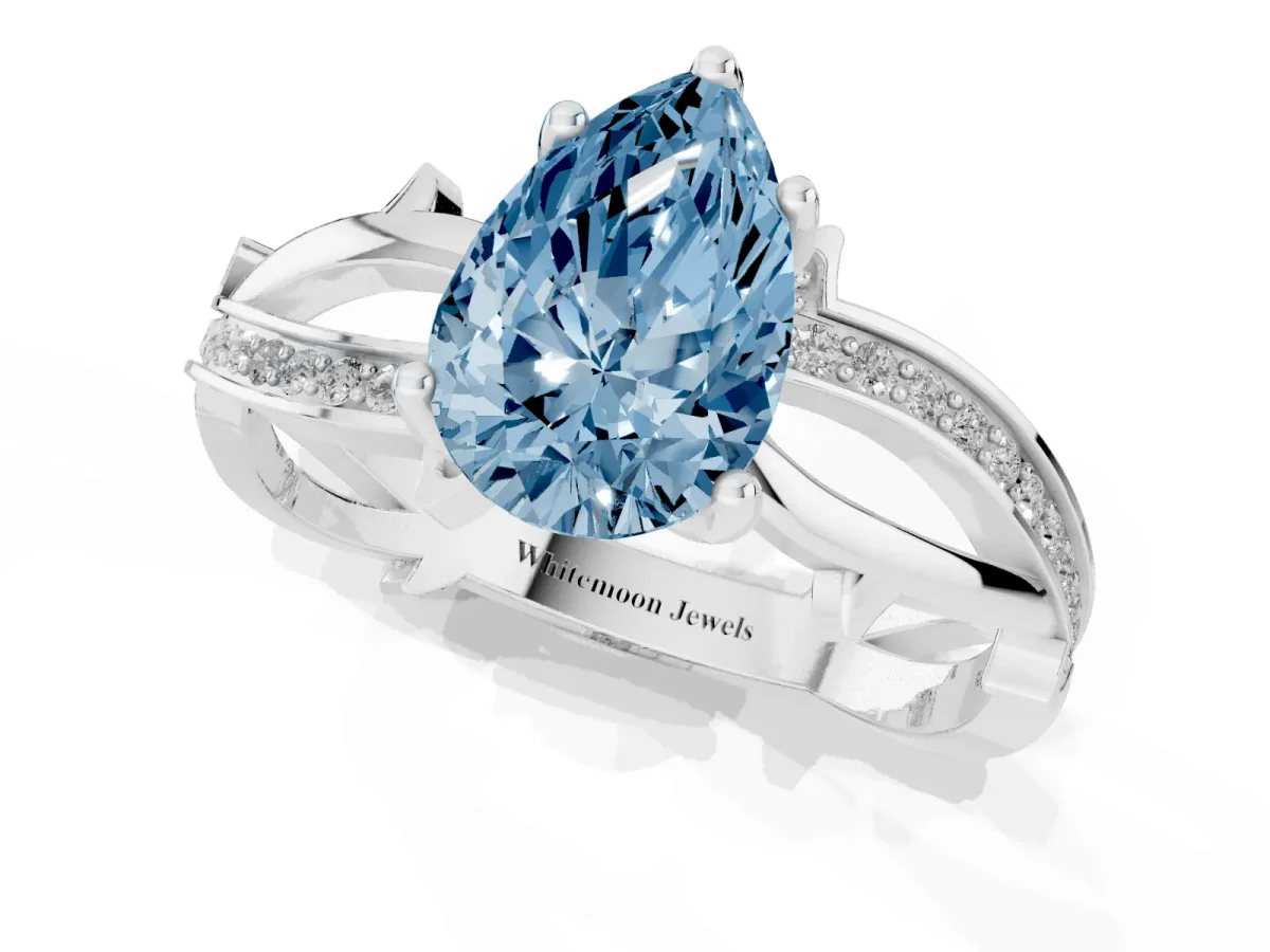 Fancy Blue Pear Cut Solitaire Twist Band with Pavé Accents and Four-Prong Setting Platinum