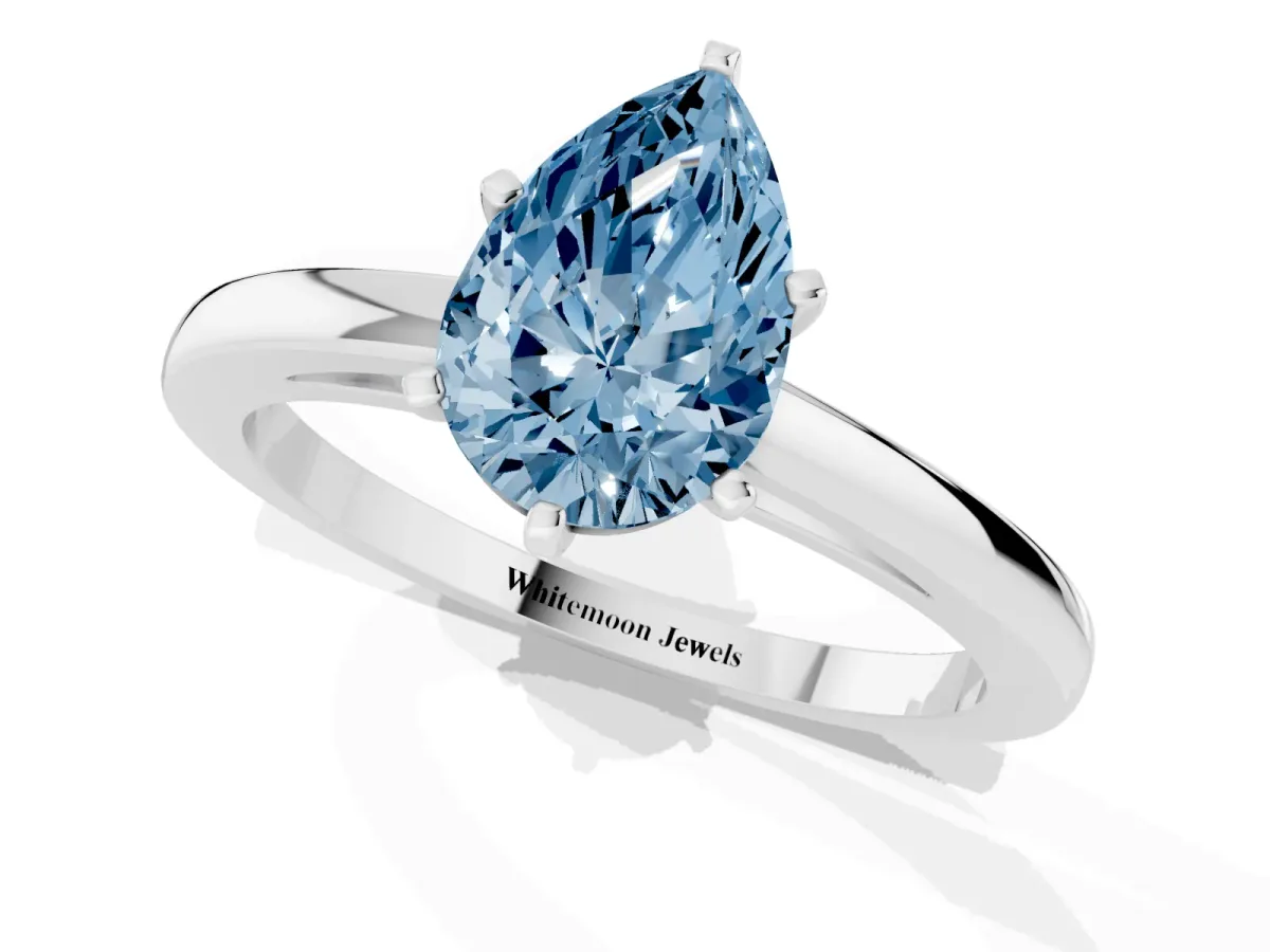 Fancy Blue Pear Cut Solitaire Diamond Engagement Ring with Four-Prong Setting on a Classic Band Silver