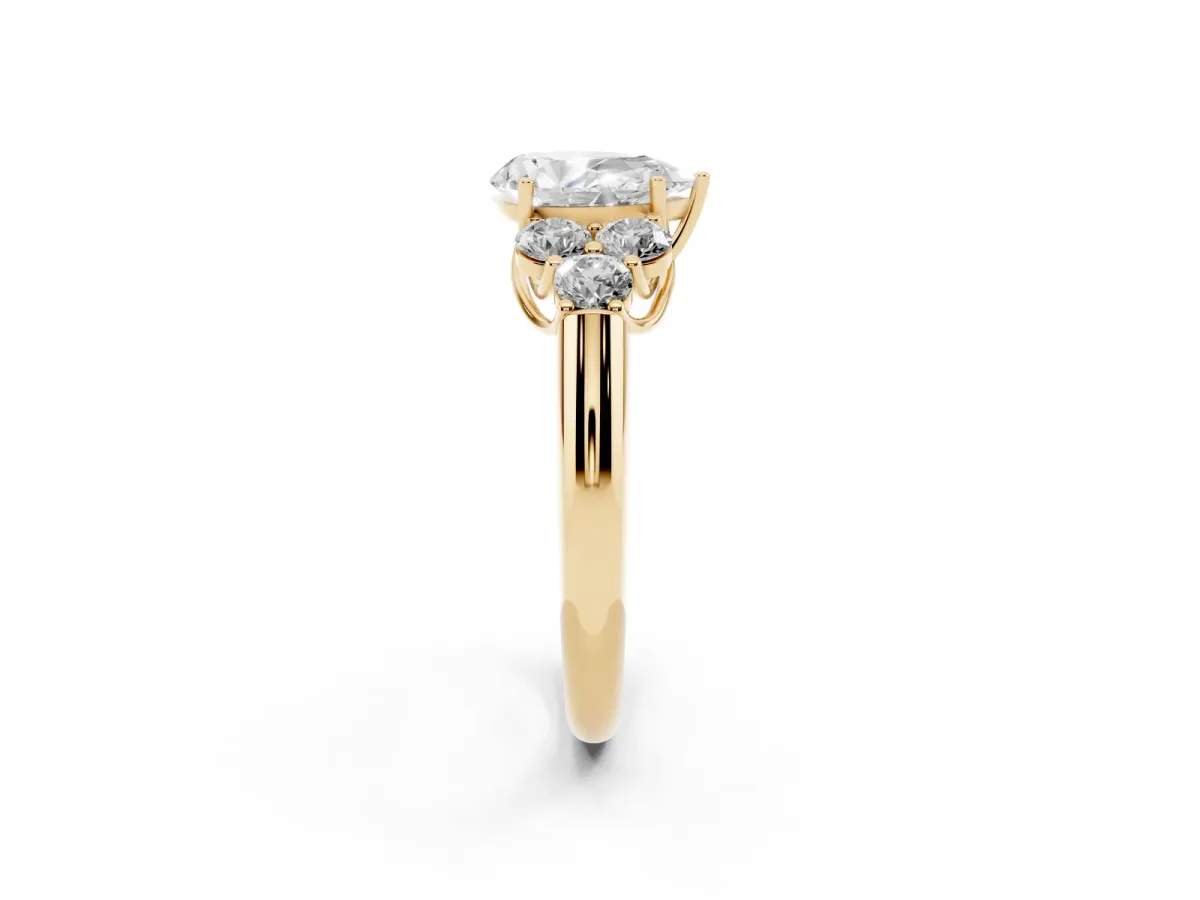 Pear Cut Cut Diamond Cluster Ring with Round Accent Stones and Prong Setting on a Classic Band Yellow gold