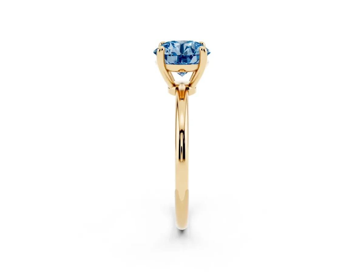 Fancy Blue Round Cut Solitaire Diamond Ring with 4-Prong Setting on a Classic Band Yellow gold