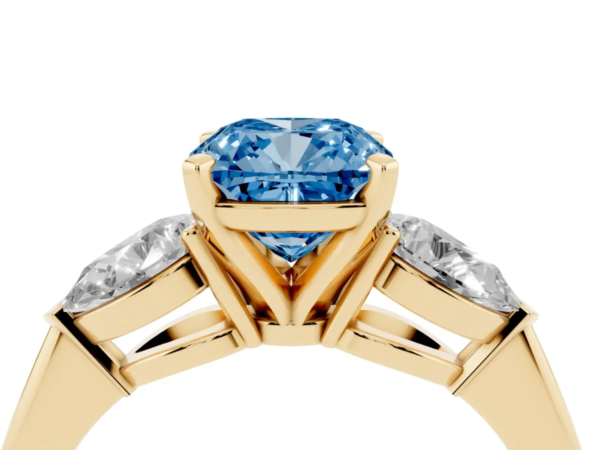 Fancy Blue Three-Stone Cushion Cut Diamond Ring with Pear Side Stones and Four-Prong Setting Yellow gold