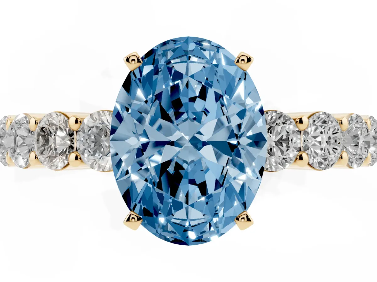 Fancy Blue Oval Cut Diamond Solitaire Ring with Shared Prong Round Side Stones Yellow gold