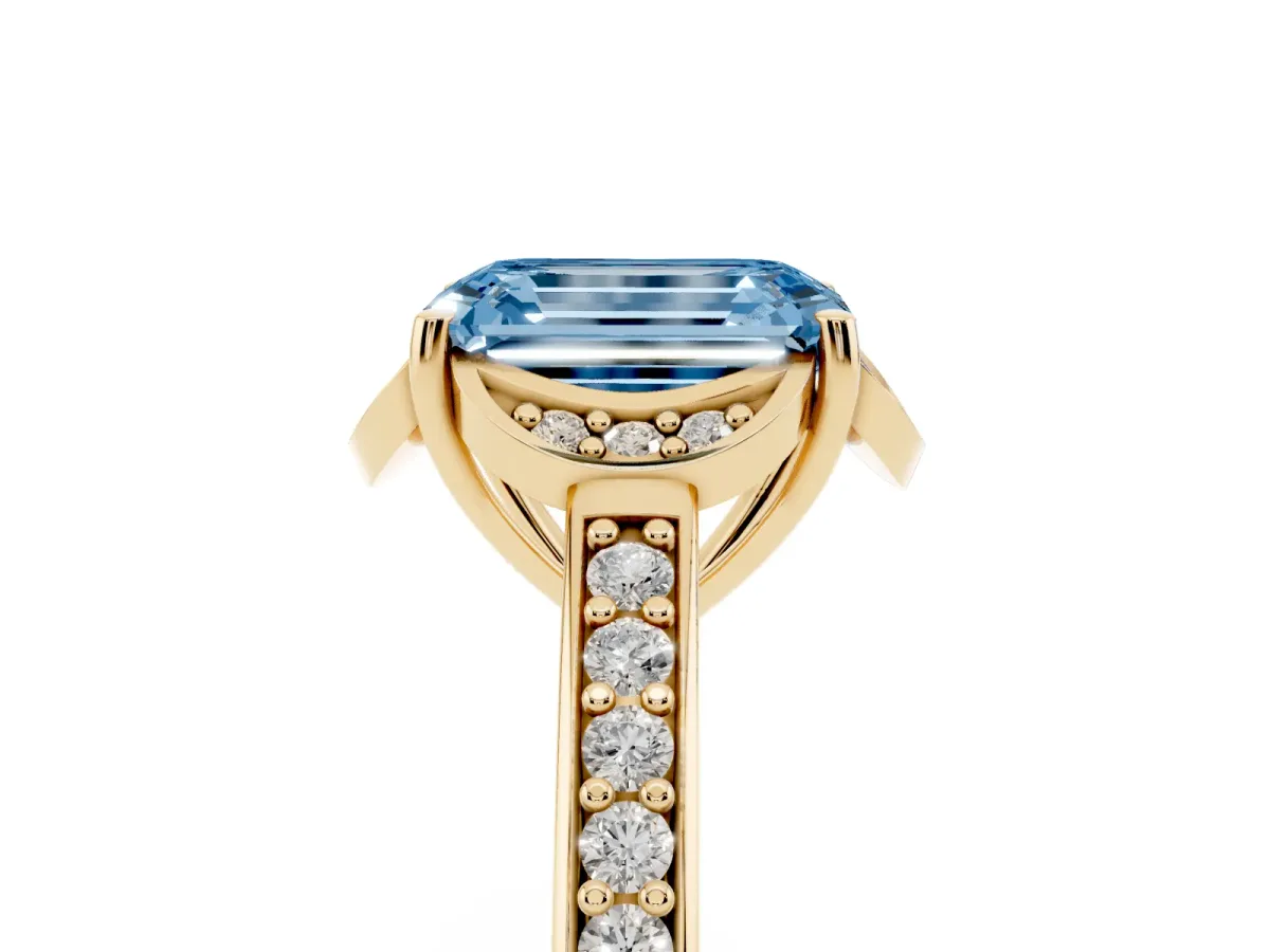 Fancy Blue Emerald Cut Cut Halo Diamond Ring with Channel Set Band and Four-Prong Setting Yellow gold