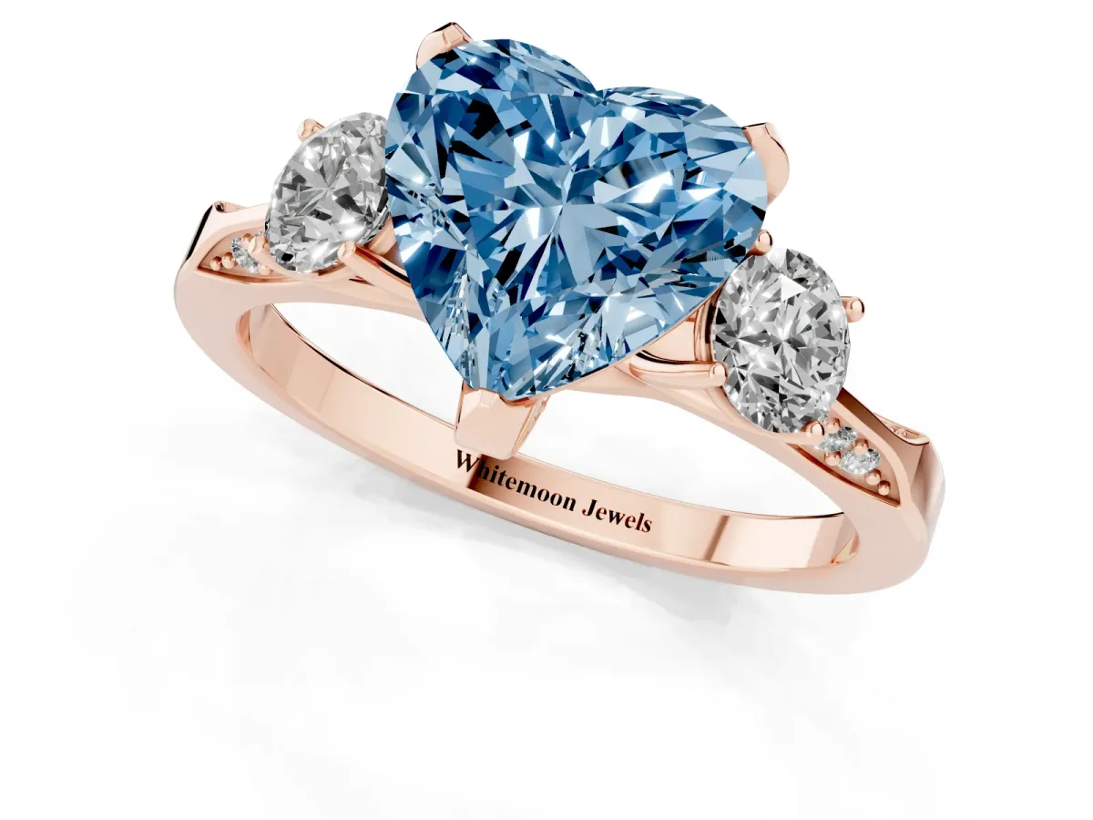 Fancy Blue Heart Cut Brilliant Three-Stone Diamond Ring with Pavé Band and Four-Prong Setting Rose gold