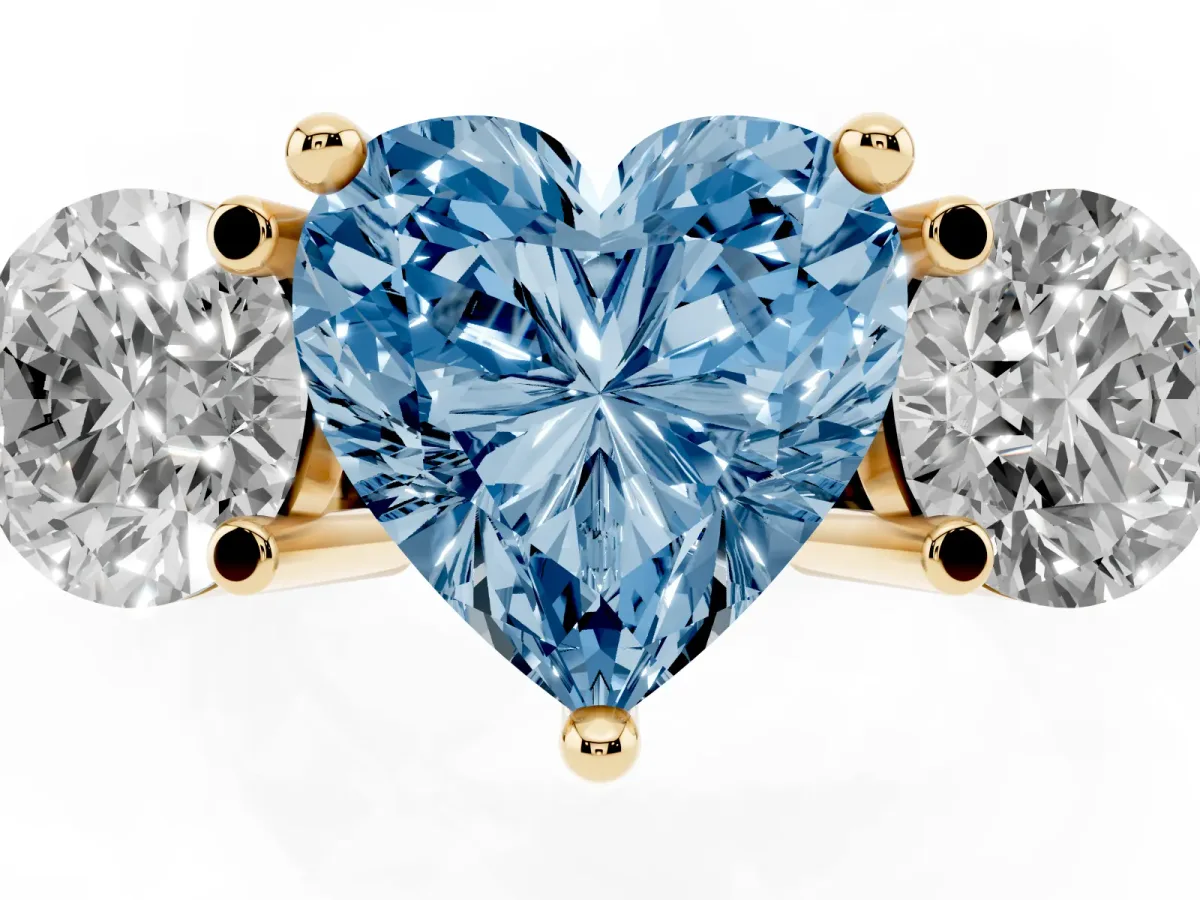 Fancy Blue Three-Stone Heart Cut Brilliant Cut Solitaire Ring with Prong Setting on a Classic Band Yellow gold
