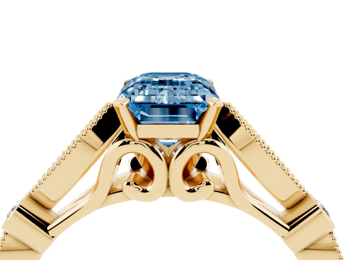 Fancy Blue Emerald Cut Cut Diamond with Milgrain Marquise and Bezel Accents on a Solitaire Band with Prong Setting Yellow gold