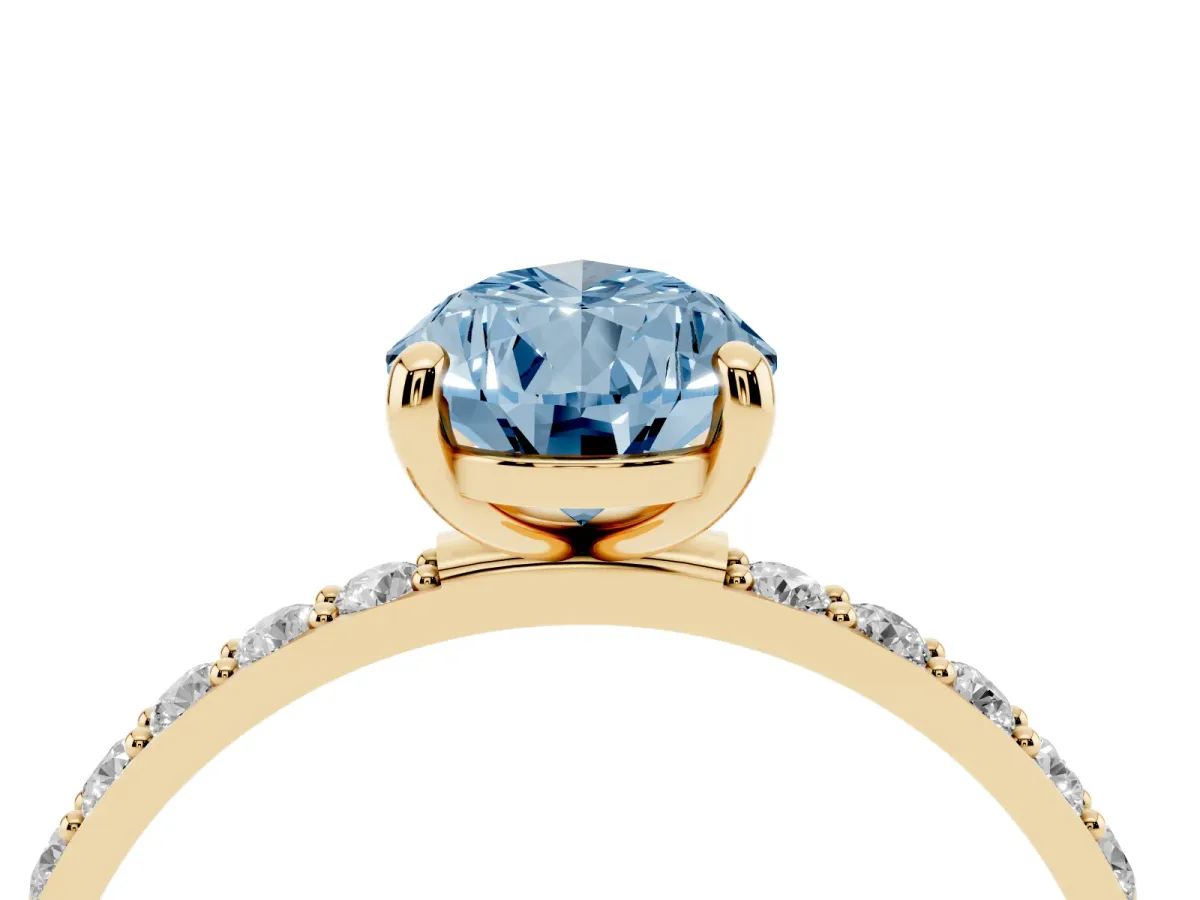 Fancy Blue Pear Cut Diamond Solitaire Ring with Round Pavé Band and Prong Setting Yellow gold
