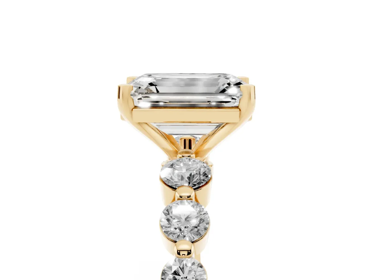 Emerald Cut Solitaire Diamond Ring with Pave Band and Four-Prong Setting Yellow gold