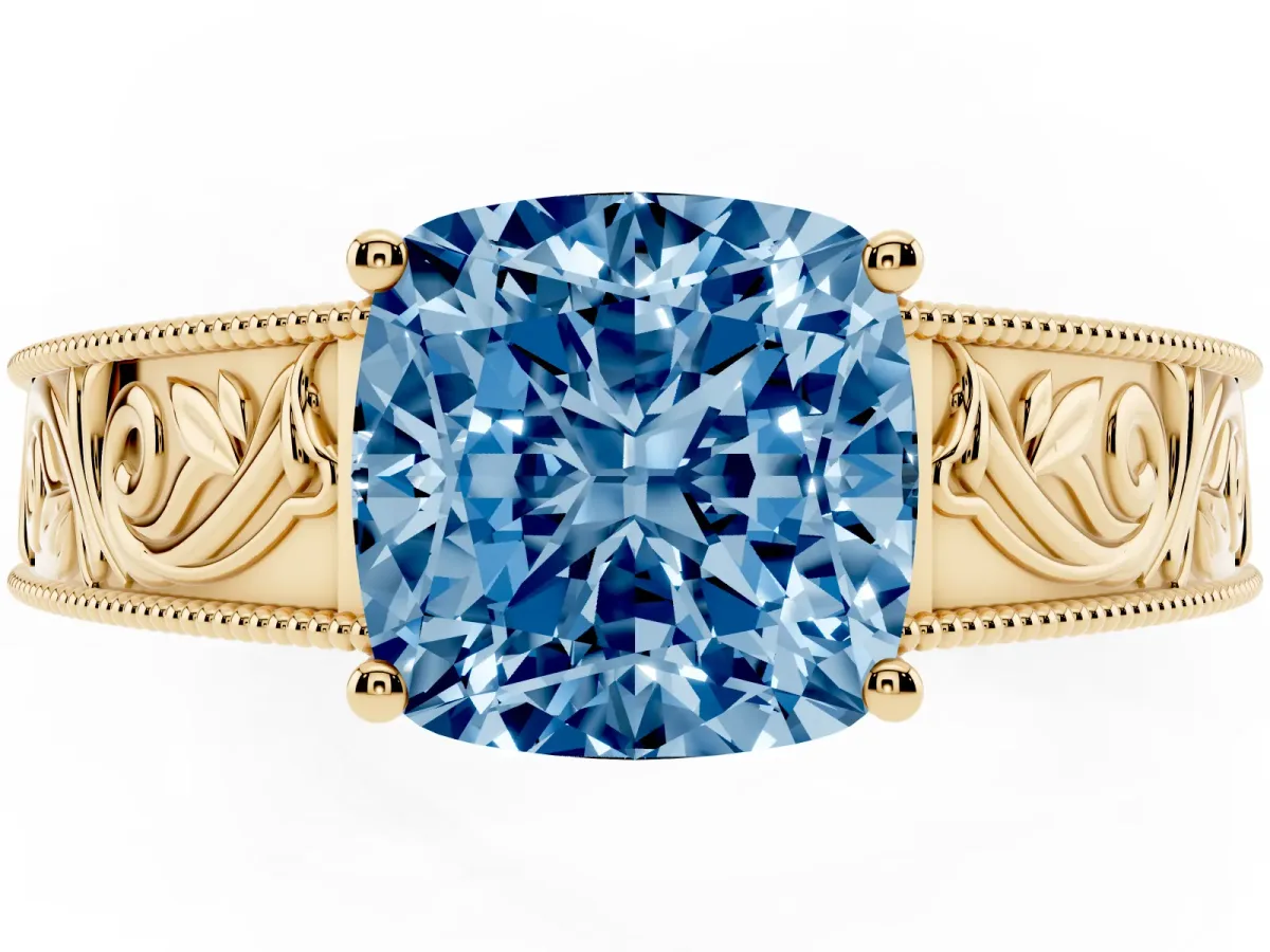 Fancy Blue Cushion Cut Diamond Solitaire Ring with Engraved Band and Four-Prong Setting Yellow gold