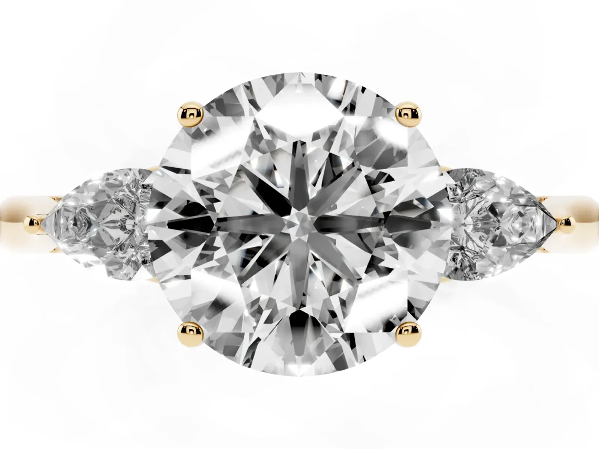 Three-Stone Round Cut Diamond Ring with Pear Side Stones in Four-Prong Setting Yellow gold