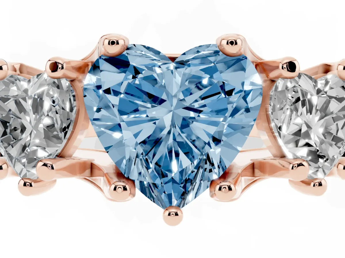 Fancy Blue Heart Cut Diamond Three-Stone Ring with Channel Set Band and Four-Prong Setting Rose gold