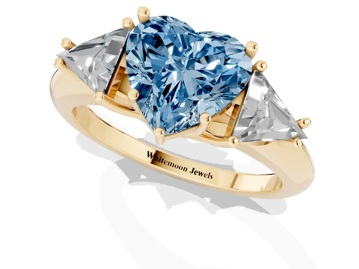 Fancy Blue Three-Stone Heart Cut Diamond Engagement Ring with Trillion Side Stones and Prong Setting Yellow gold