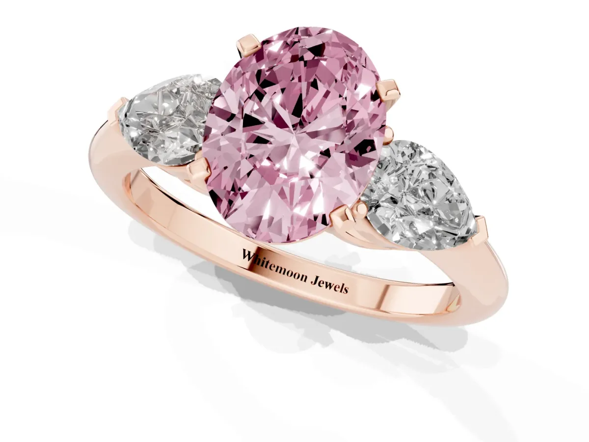 Fancy Pink Three-Stone Oval Cut Diamond Ring with Pear Side Stones and Four-Prong Setting Rose gold