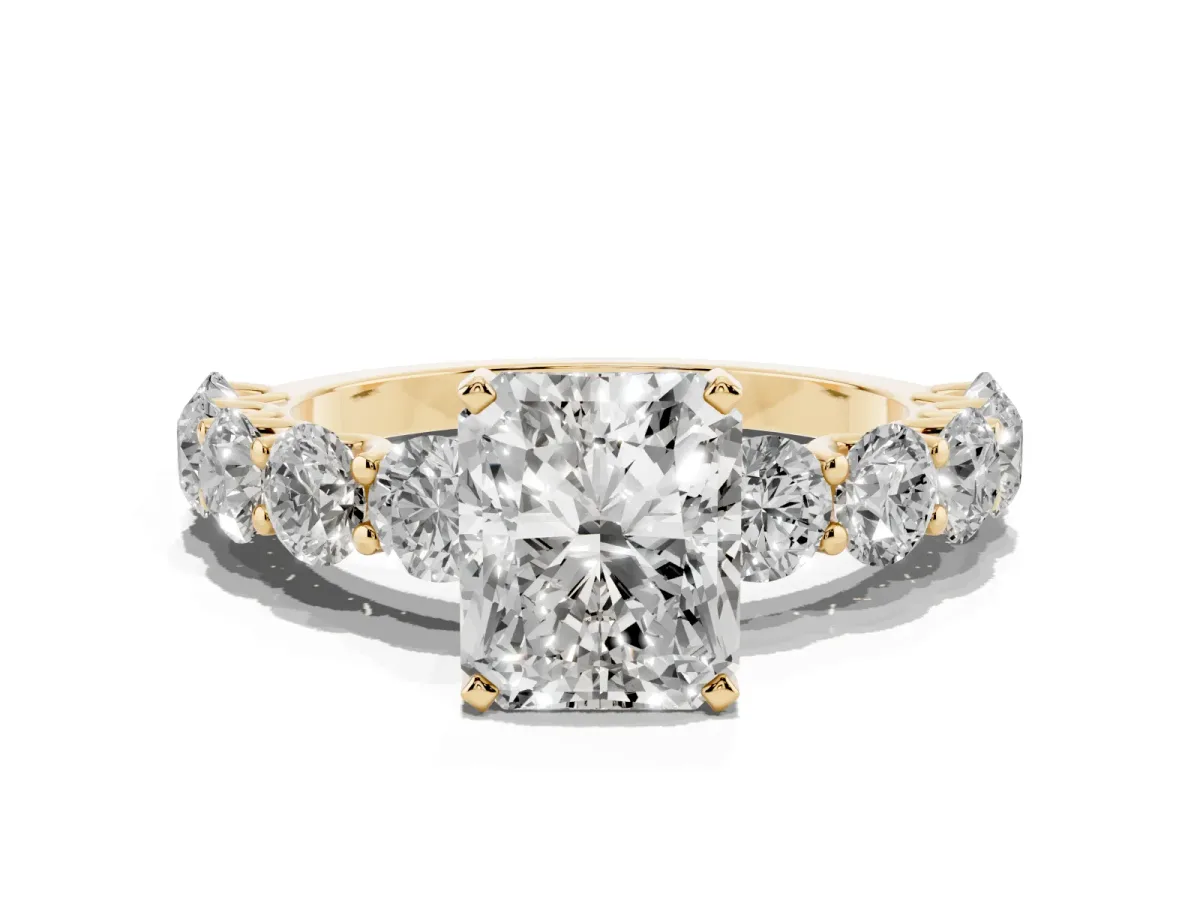 Radiant Cut Diamond Prong Setting with Side Stones on a Pave Band Yellow gold