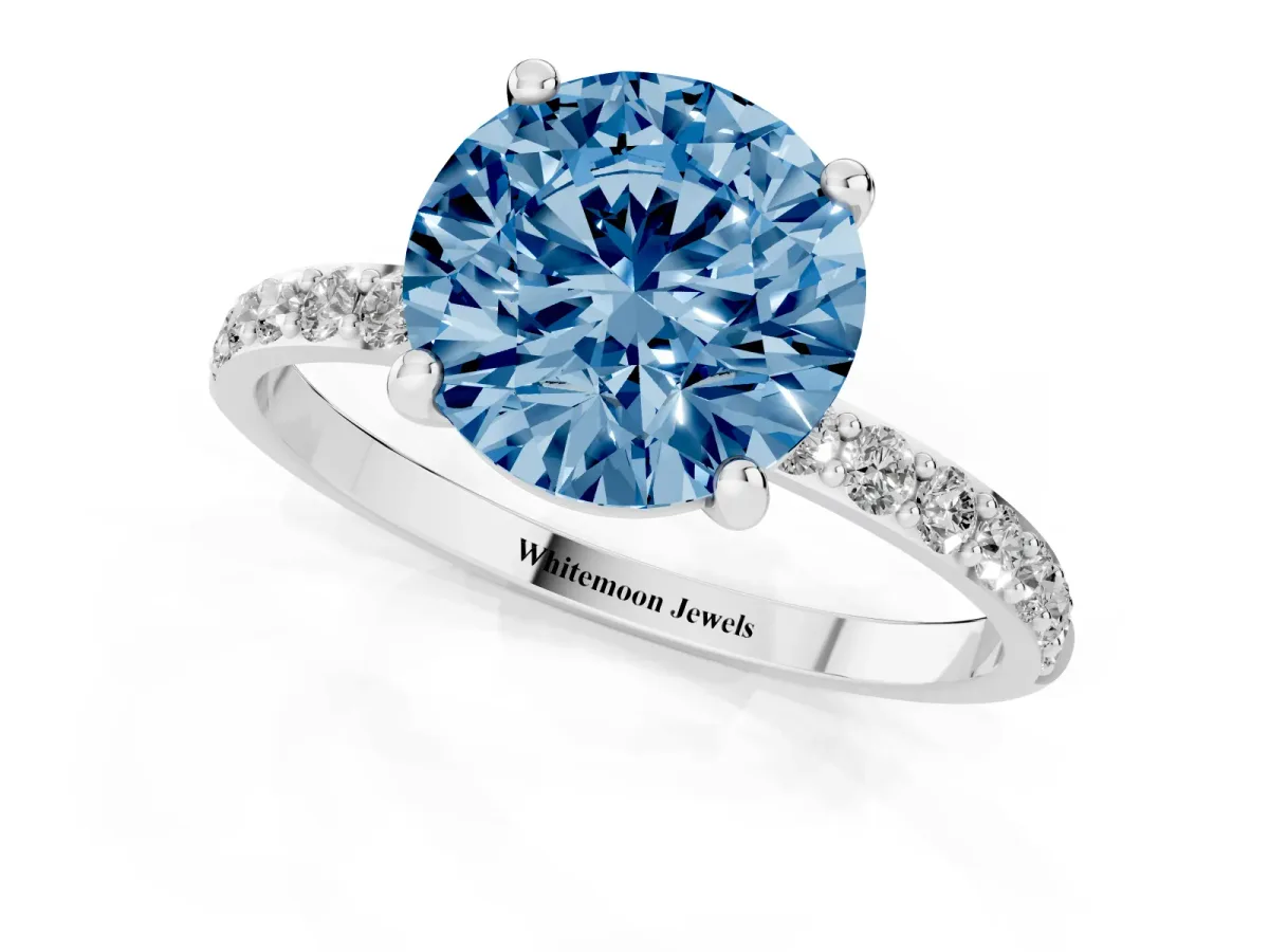 Fancy Blue Round Cut Diamond Solitaire Ring with Round Pavé Band and Prong Setting Silver