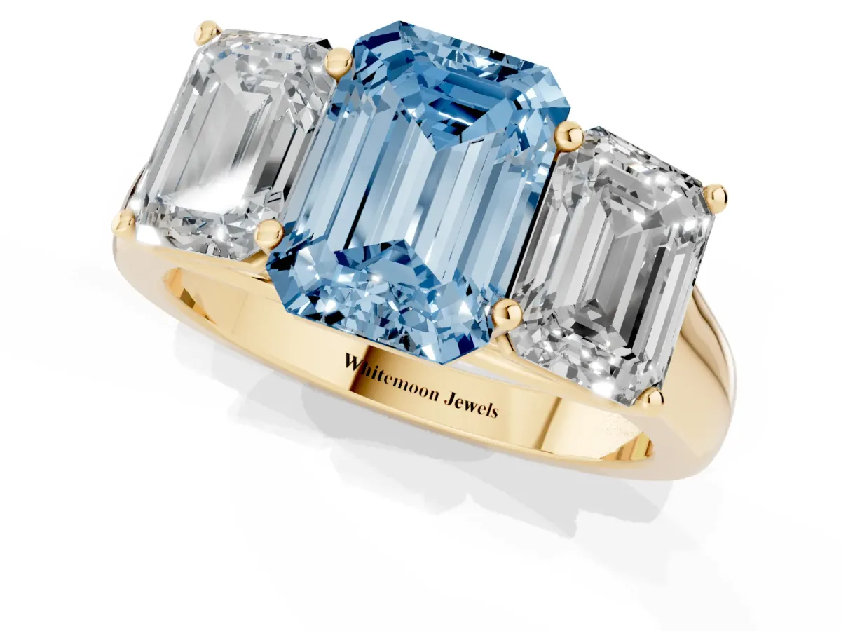 Fancy Blue Emerald Cut Three-Stone Diamond Ring with Prong Setting on a Classic Band Yellow gold